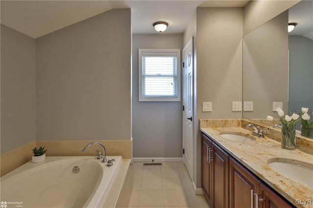 full bath featuring tile patterned flooring, a garden tub, double vanity, and a sink