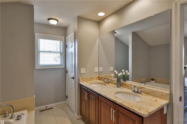 bathroom with double vanity, visible vents, a garden tub, and a sink