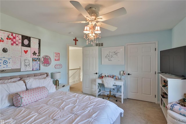 bedroom with visible vents, light colored carpet, and a ceiling fan