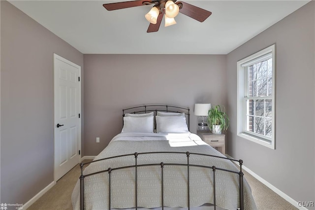 bedroom featuring ceiling fan, baseboards, and light carpet