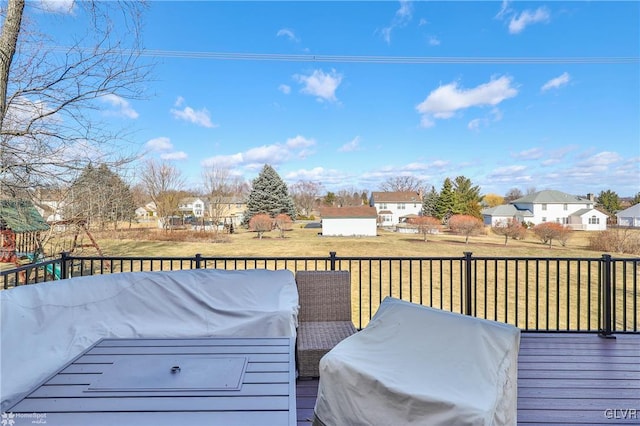 wooden deck with a yard and a grill