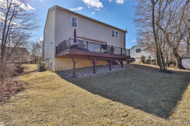 rear view of house with a deck, a yard, and central AC unit