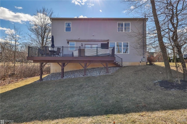 rear view of property with a lawn and a deck