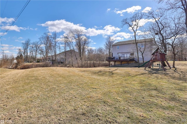 view of yard featuring a deck and a playground