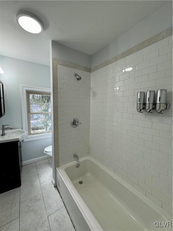 full bath featuring tile patterned flooring, baseboards, toilet, shower / bathing tub combination, and vanity