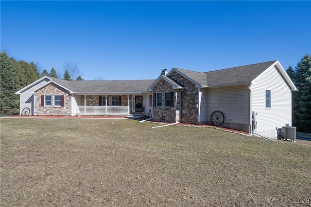 ranch-style home with stone siding, covered porch, cooling unit, and a front lawn