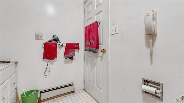 bathroom featuring tile patterned floors, a baseboard radiator, and vanity