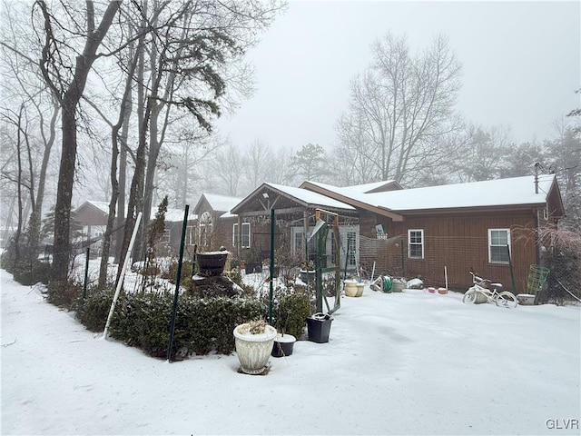 view of snow covered rear of property