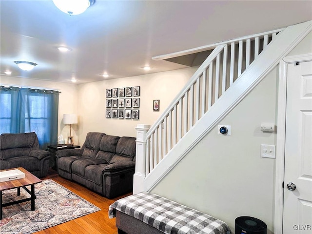 living room featuring wood finished floors and stairs