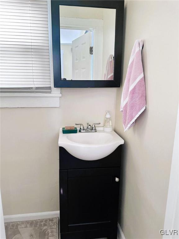 bathroom with vanity and baseboards