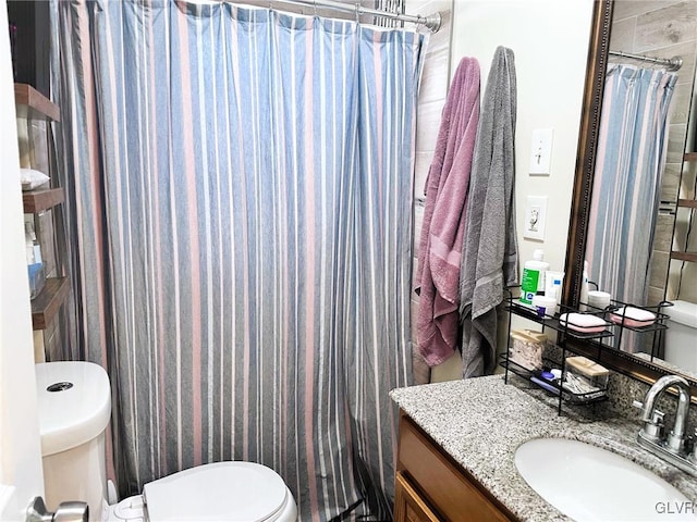 bathroom with a shower with curtain, toilet, and vanity