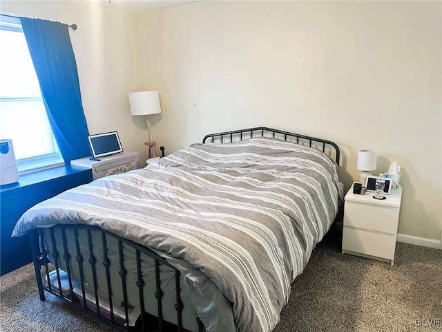 bedroom featuring baseboards and carpet floors