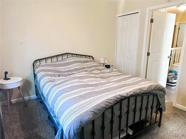 bedroom featuring carpet, baseboards, and a closet