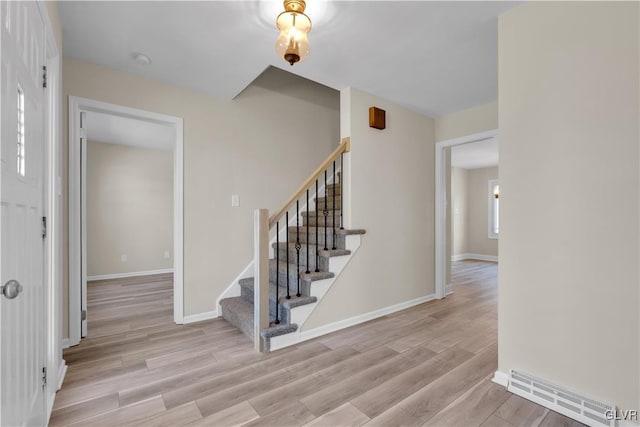 interior space with visible vents, baseboards, and wood finished floors