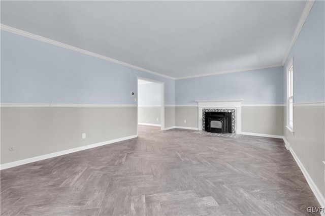 unfurnished living room with baseboards and ornamental molding