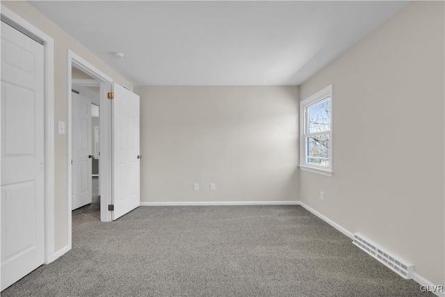 unfurnished bedroom with visible vents, baseboards, and carpet