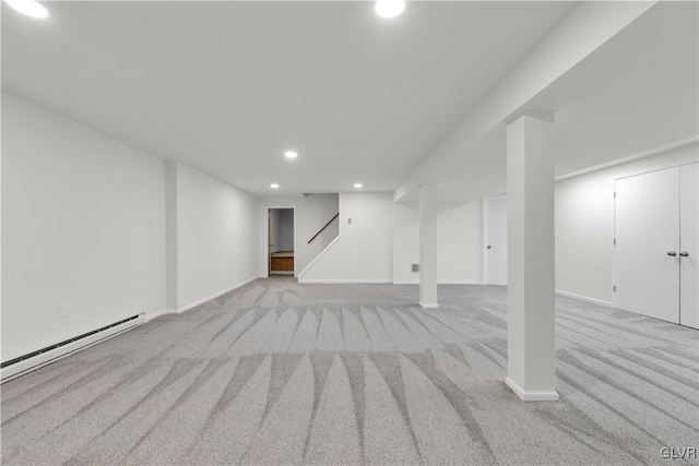 finished basement featuring baseboards, stairway, carpet floors, baseboard heating, and recessed lighting