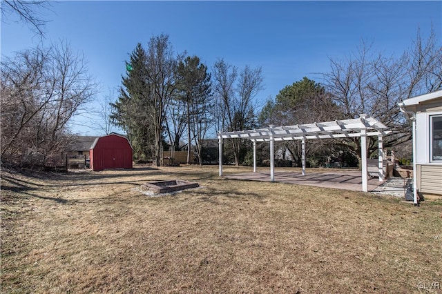 view of yard featuring a patio area, a pergola, and an outbuilding