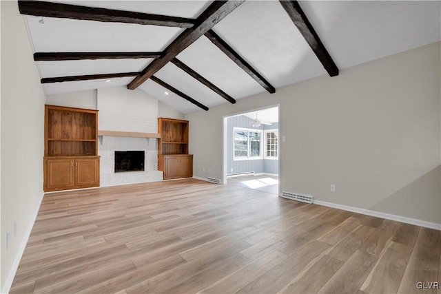 unfurnished living room featuring light wood finished floors, visible vents, a brick fireplace, vaulted ceiling with beams, and baseboards