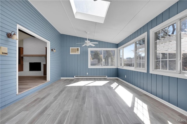 unfurnished sunroom with a baseboard radiator, lofted ceiling with skylight, and ceiling fan