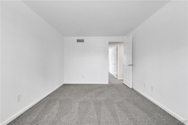 empty room with visible vents, carpet flooring, and baseboards