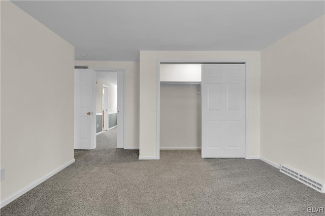 unfurnished bedroom featuring visible vents, carpet floors, and baseboards