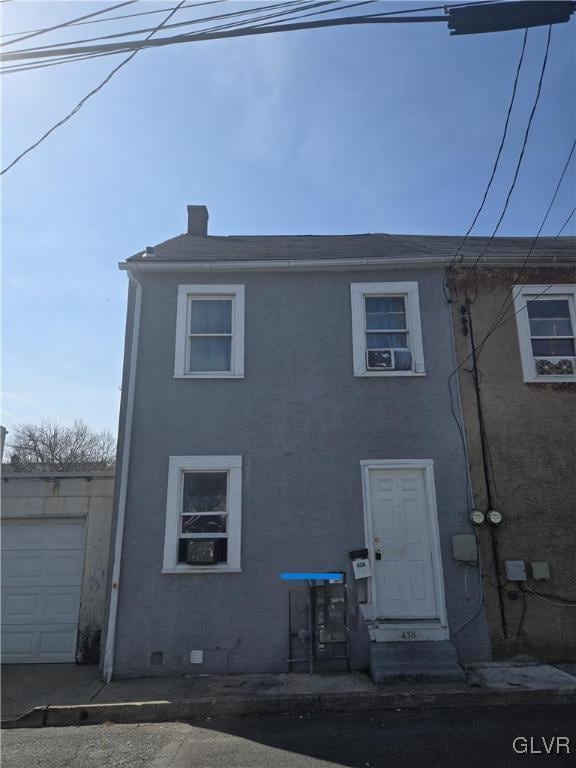 back of property featuring stucco siding