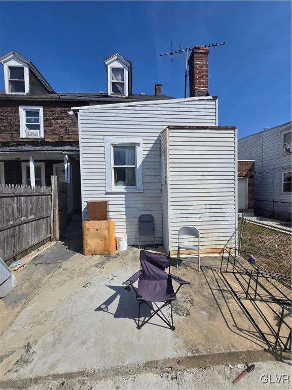 rear view of property with a patio area and fence