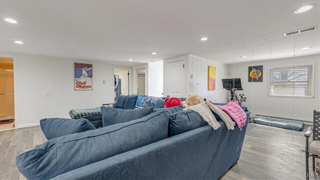 living area with visible vents, recessed lighting, baseboards, and wood finished floors