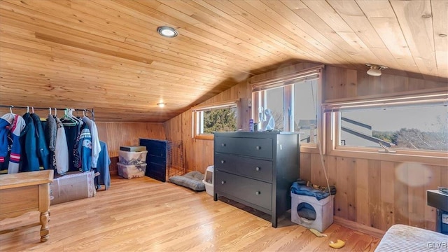 interior space with wooden ceiling, wooden walls, wood finished floors, and lofted ceiling