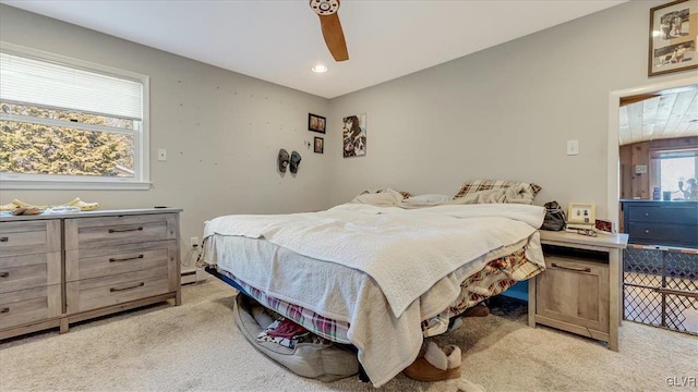 bedroom with recessed lighting, a baseboard radiator, light colored carpet, and a ceiling fan