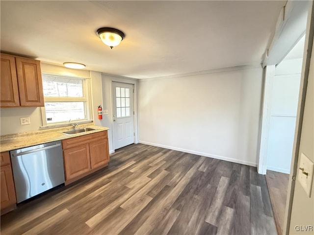 kitchen with a sink, stainless steel dishwasher, light countertops, baseboards, and dark wood-style flooring