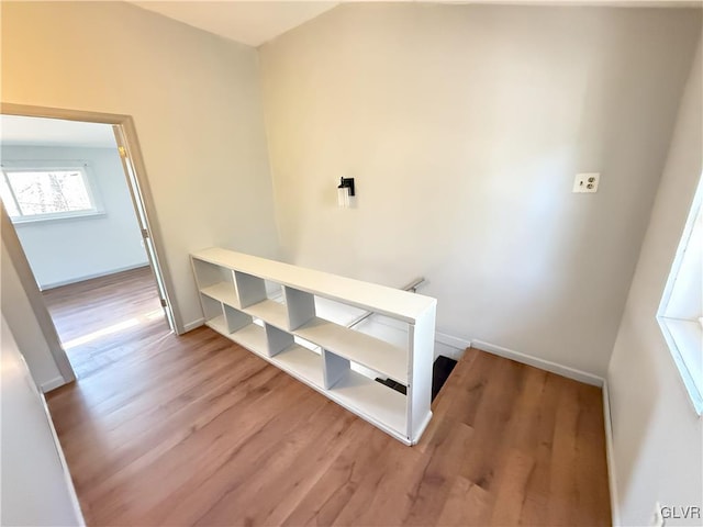 hallway with wood finished floors and baseboards