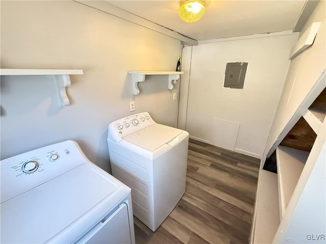 laundry area featuring electric panel, dark wood-type flooring, washing machine and dryer, and laundry area