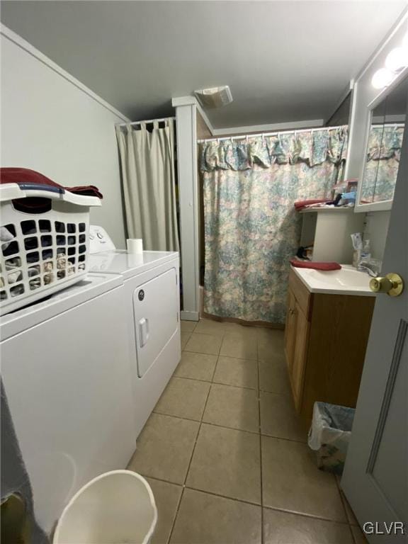 full bathroom featuring washer and clothes dryer, tile patterned floors, vanity, and a shower with shower curtain