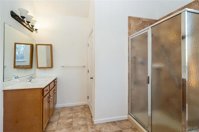 full bathroom with a shower stall, vanity, and baseboards