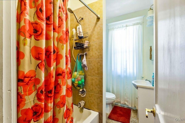 bathroom with shower / bathtub combination with curtain, toilet, and vanity