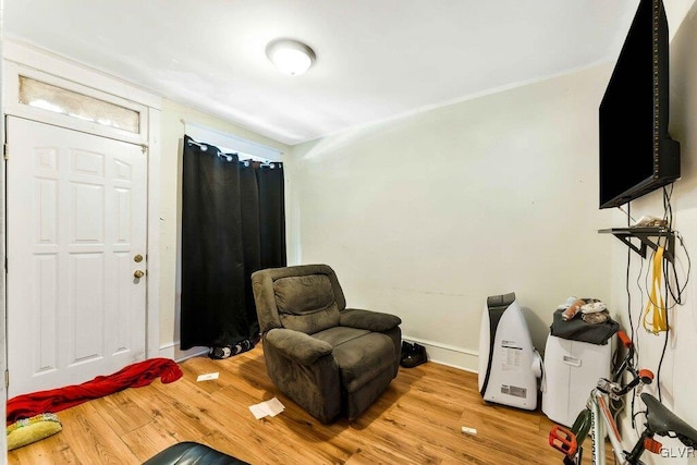 living area with light wood-style flooring and baseboards