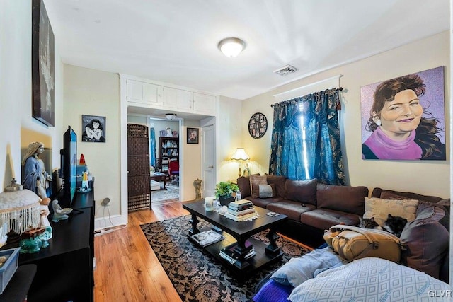 living room with light wood finished floors and visible vents