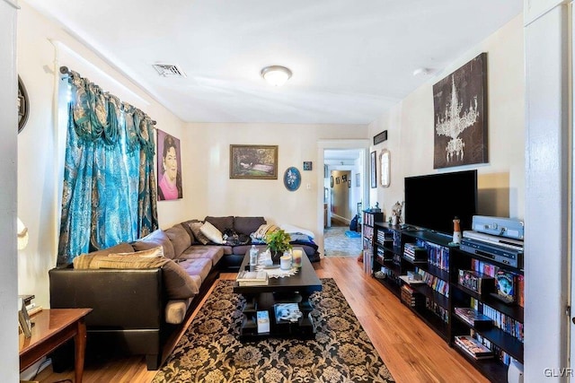 living area featuring wood finished floors and visible vents