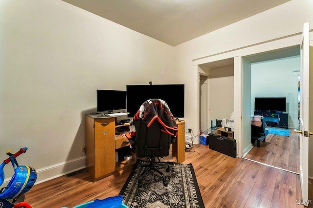 office featuring baseboards and wood finished floors