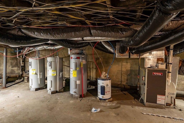 unfinished basement featuring heating unit and electric water heater