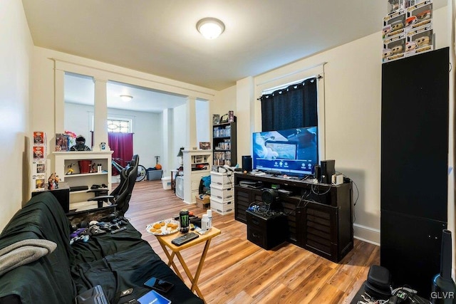 living room with light wood-type flooring and baseboards