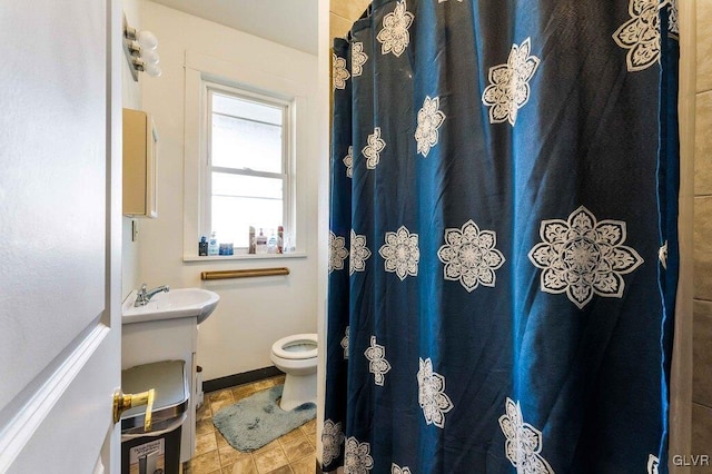 bathroom featuring curtained shower, toilet, and vanity