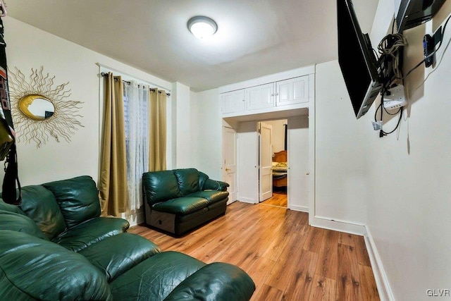 living room featuring light wood-type flooring and baseboards