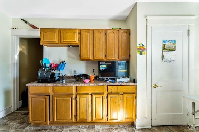 kitchen with brown cabinets and a sink