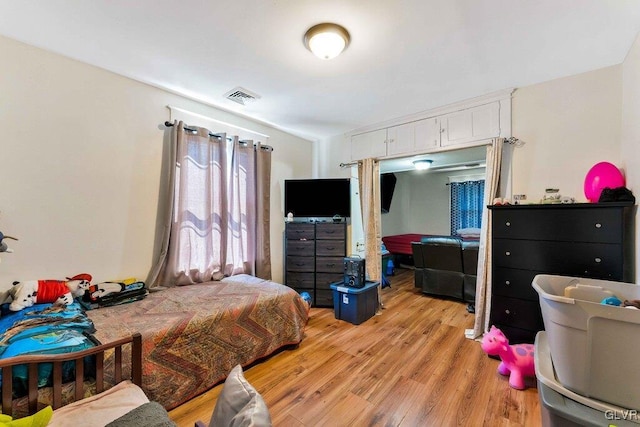 bedroom featuring visible vents and light wood-type flooring