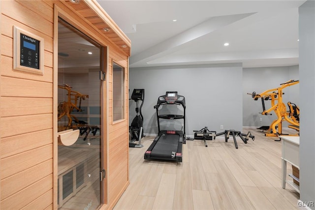 exercise room with recessed lighting, baseboards, a sauna, and light wood-style flooring