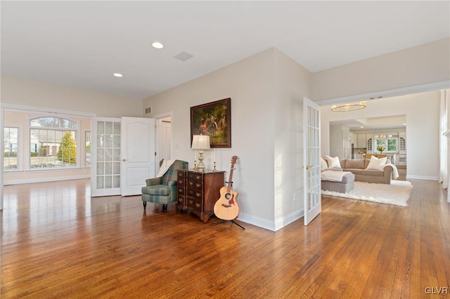 living area with wood finished floors, french doors, and a wealth of natural light