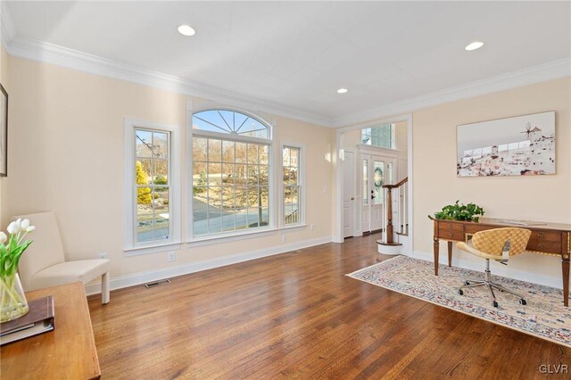 foyer entrance featuring wood finished floors, visible vents, and ornamental molding